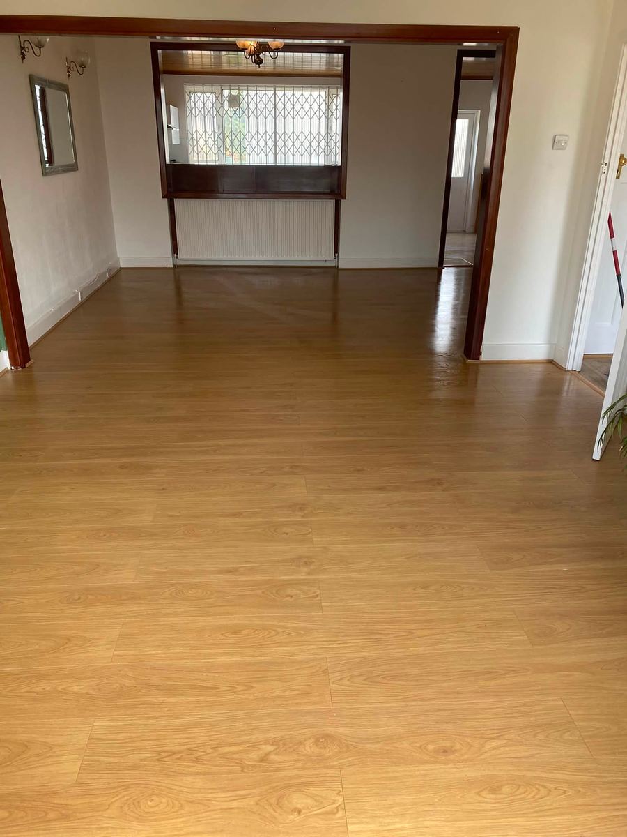Empty through lounge with a wood-effect floor
